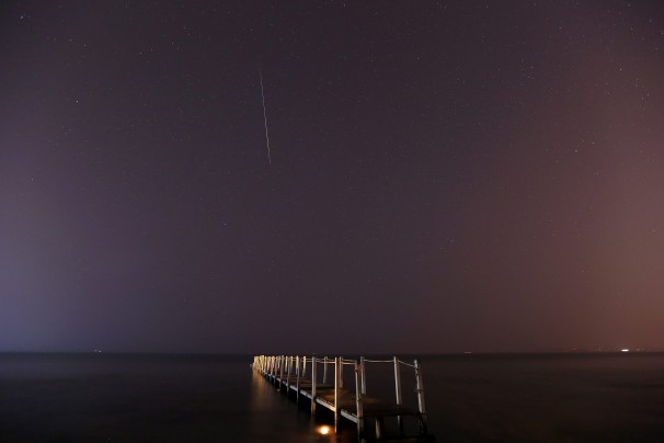 A long-exposure photo shows a meteor burning up in the atmosphere over a beach in Anavissos, Greece WP A long-exposure photo shows a meteor burning up in the atmosphere over a beach in Anavissos, Greece WP